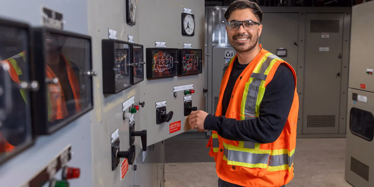 BCRTC engineer smiling while opening electrical panel