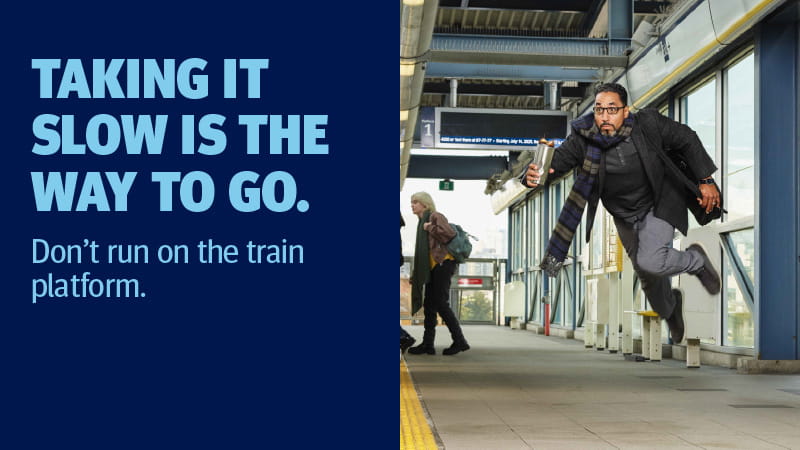 A man running towards the train platform in a hurry.