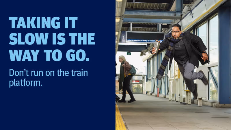 A man running towards the train platform in a hurry.